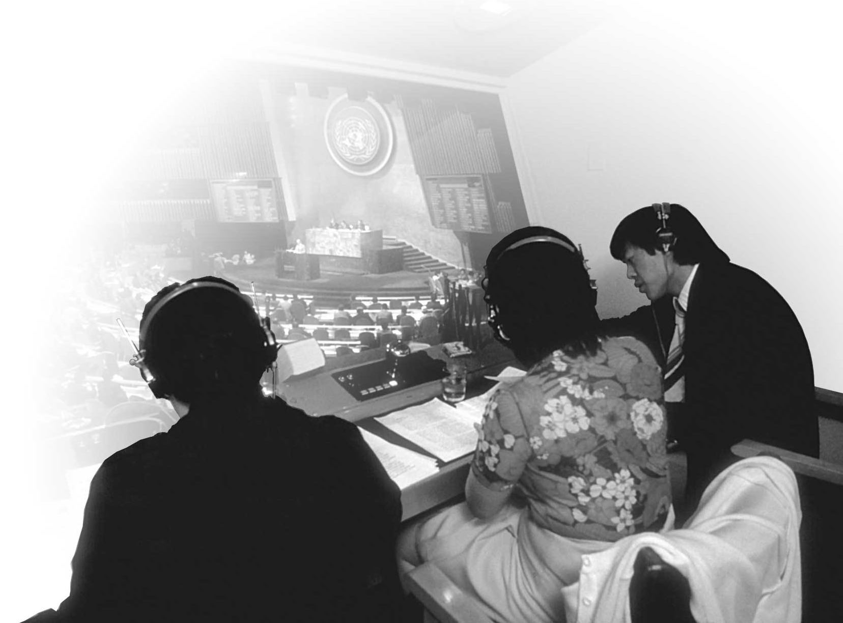 Interpreters at work in a UN conference booth, black and white photograph