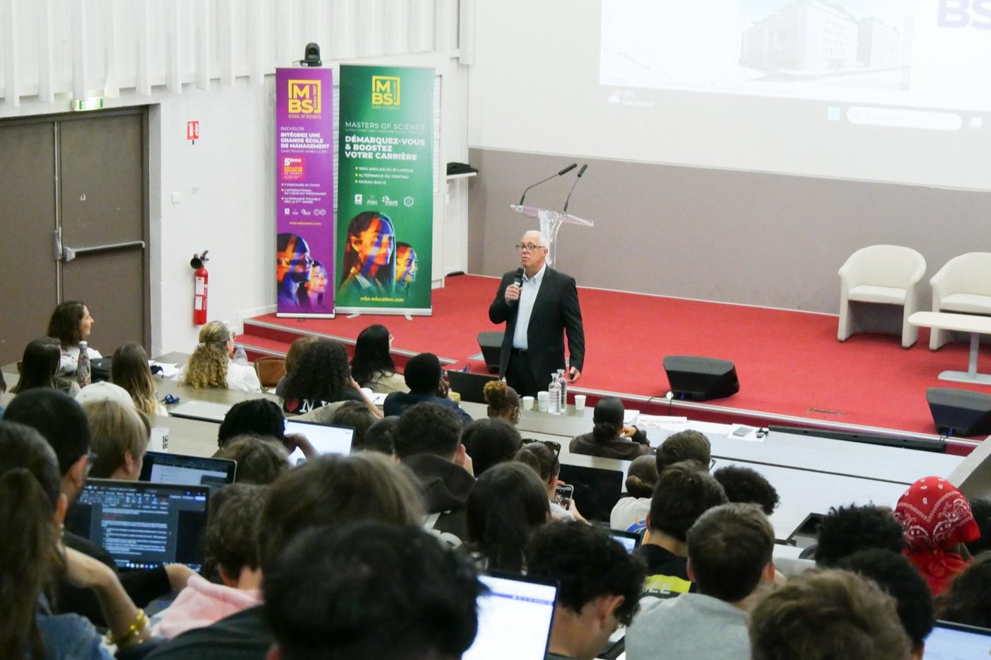Speaker presenting to a lecture hall of students