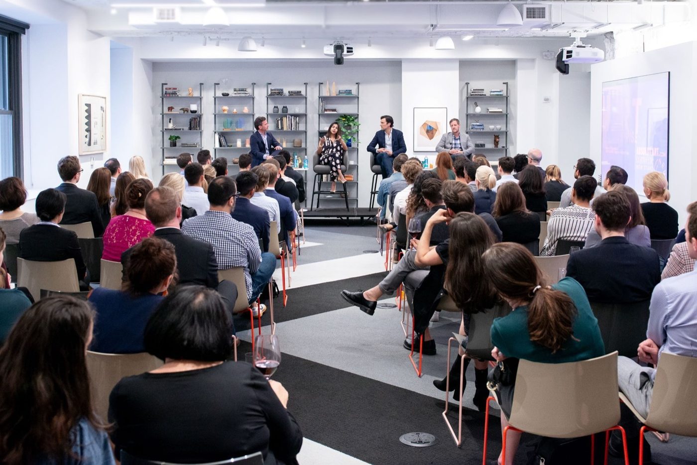 Panel discussion in a bright meeting room in front of an audience