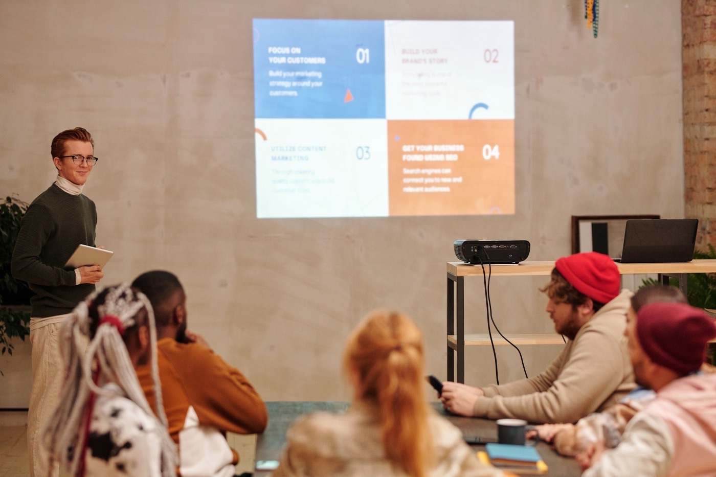 Speaker presenting slides to a small seated audience